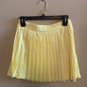 PEPPERMAYO Pleated yellow mini tennis skirt.